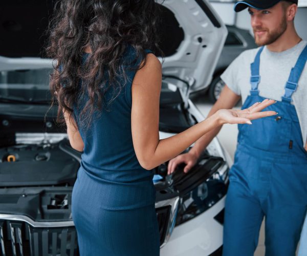 about-that-crash-woman-in-the-auto-salon-with-employee-in-blue-uniform-taking-her-repaired-car-back-1.jpg